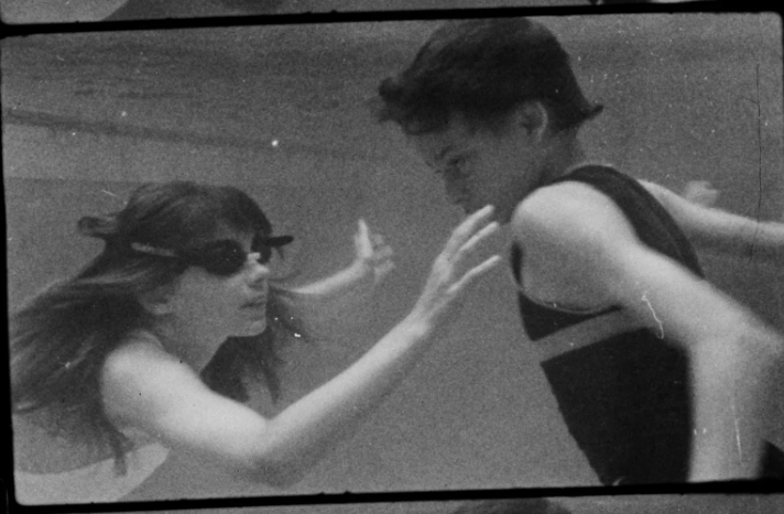 An image of a boy and girl underwater, from the film Chlorine Dreams