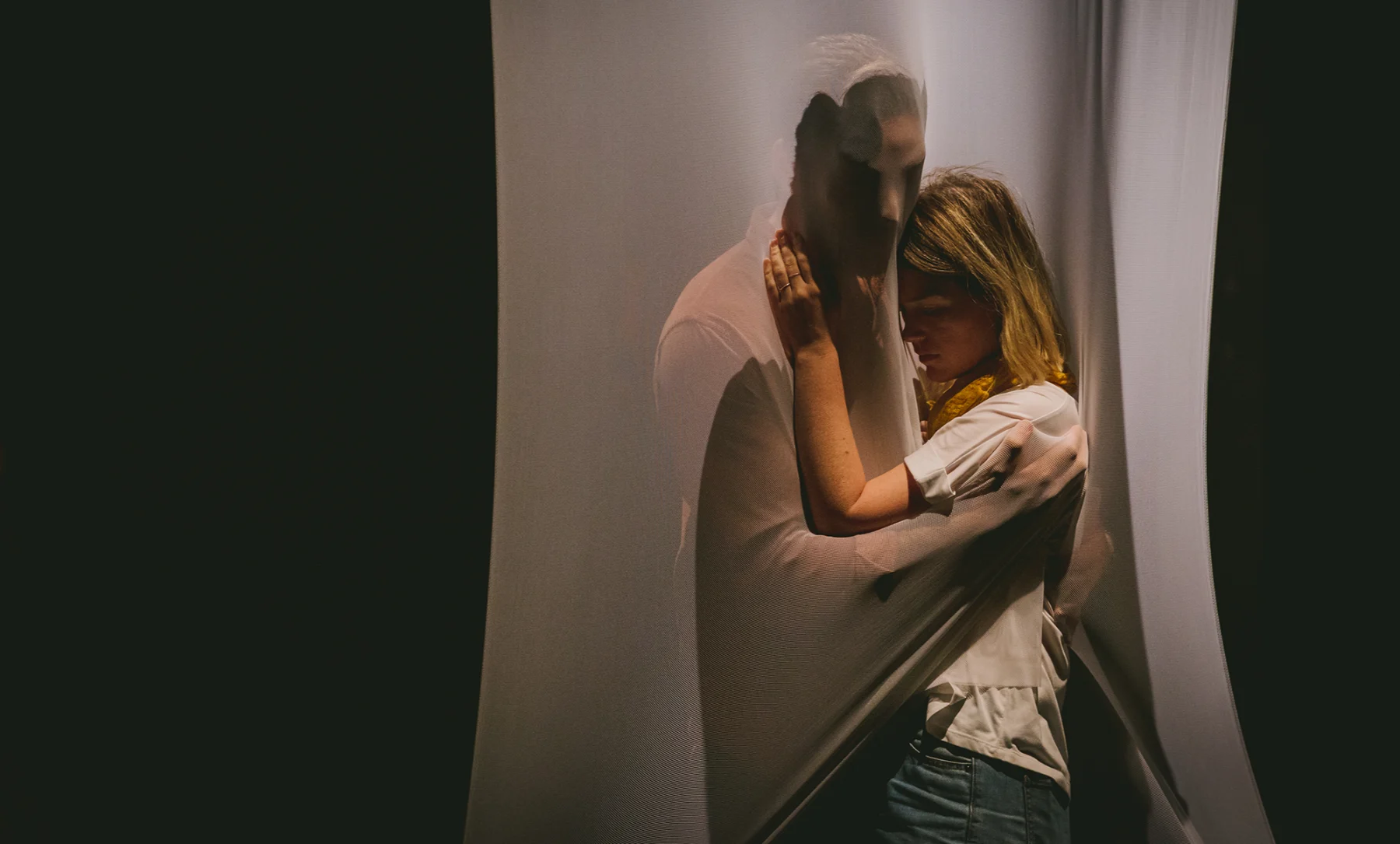 A man and women embracing, an image from a scene in a theatre piece from Sofya Gollan